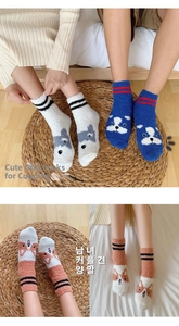 Detailed view of warm thick coral fleece crew socks featuring cute cartoon dog patterns