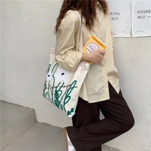 Japanese style chamomile print canvas tote bag with artistic lettering on white fabric