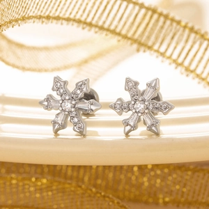 Elegant silver snowflake stud earrings with sparkling zircon stones in a close-up view