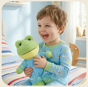 Detail of green frog plush toy in blue star-patterned pajamas in a cozy bedroom setting