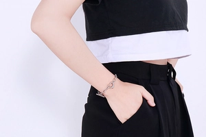Silver OT buckle heart bracelet on wrist showing a fashion heart link chain design