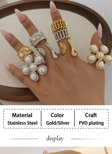 Detail of PVD plated stainless steel rings with pearl accents worn on model's fingers