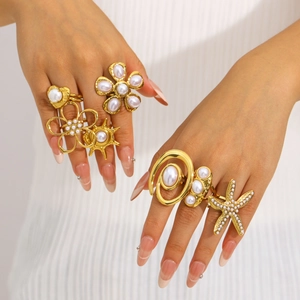 Gold-plated stainless steel flower and starfish rings with pearls shown on hand