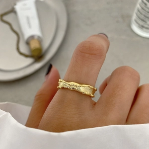 Irregular lava texture S925 sterling silver ring with gold finish on model finger