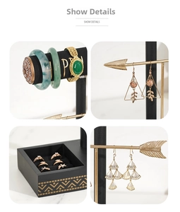 Detail view of T-bar jewelry display with gold accents, watch stand and ring slots