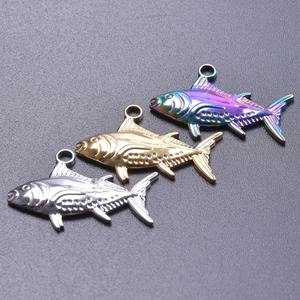 Detailed view of fish-shaped pendants in silver, gold, and rainbow vacuum plating