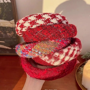 Set of premium red tweed and houndstooth headbands for women in warm indoor setting