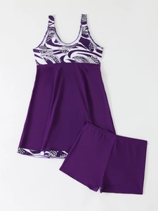 Flat lay of purple floral print tankini set with A-line swim dress and matching shorts