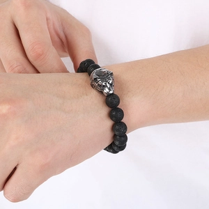 Men's 8mm black lava rock bead bracelet featuring a silver tiger head charm on model