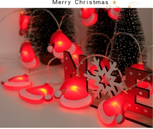 Detail of red and white Santa hat LED string lights with warm festive lighting glow