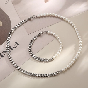 Detail view of pearl and titanium steel Cuban chain necklace and bracelet jewelry set