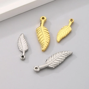 Detailed view of hollow leaf pendants in gold and silver finishes for jewelry making