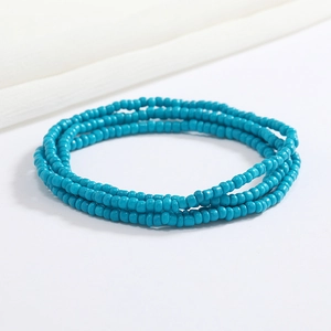 Macro shot of 2mm handmade cyan glass beaded elastic waist chain with vibrant colors
