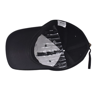 Detail of black cotton baseball cap interior with 100% cotton label and adjustable strap