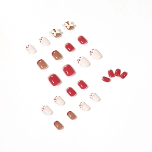 Creamy pink and red leopard print press-on nails with 3D bows and pearl accents