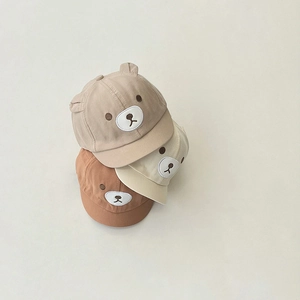 Detailed shot of baby bear baseball caps in light brown, cream, and tan soft cotton