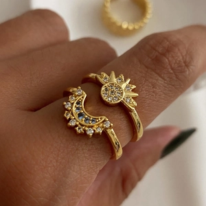 Gold celestial stacking rings set featuring sun and moon designs with zircon stones