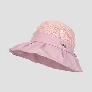 Detail of pink wide brim sun hat showing breathable knit crown and woven fabric edge