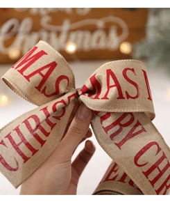 Detail of Merry Christmas burlap ribbon showing woven texture and red printed lettering