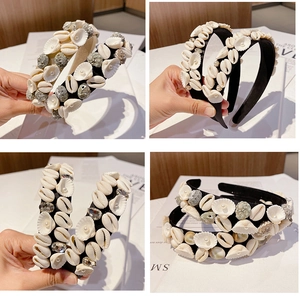 Detailed view of Baroque headband with natural white seashells, grey stones and pearls