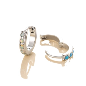 Elegant silver hoop earrings with round opal inlays on a clean reflective surface