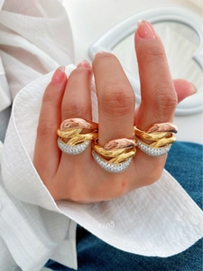 Detailed view of triple-layered gold and silver ring with micro-pave cubic zirconia