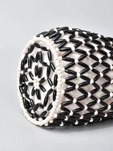 Handmade beaded bucket bag with black and white geometric patterns for summer beach travel