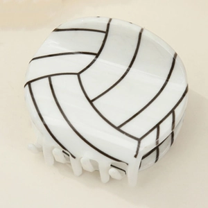 Detailed view of creative volleyball-shaped hair claw clip with black and white texture