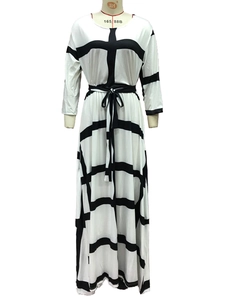 Detail of waist tie and black striped pattern on a white knit maxi dress