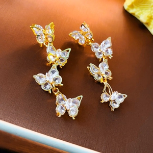 Elegant gold butterfly tassel earrings with sparkling crystals and drop chain design