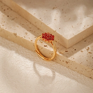 Macro shot of 18K gold-plated adjustable ring with cluster of red cubic zirconia stones