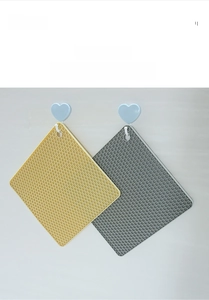 Detail of hanging silicone honeycomb mats with circular holes for kitchen storage
