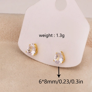 Close-up of teardrop-shaped gold-plated stud earrings with clear cubic zirconia stones