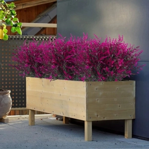 UV-resistant purple artificial lavender shrubs in a raised wooden garden planter box