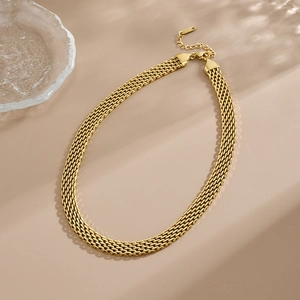 Macro shot of gold-plated flat mesh necklace featuring a polished finish and lobster clasp