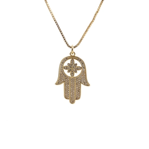 Macro detail of gold Hamsa hand pendant with sparkling crystals on a box chain necklace