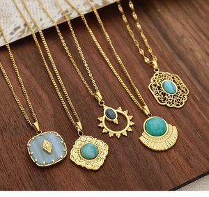 Detailed view of five vintage gold necklaces featuring turquoise geometric pendants
