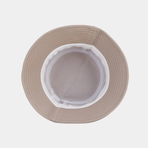 Detail view of khaki bucket hat featuring breathable mesh lining and sweatband stitching