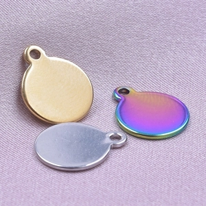 Detailed view of round metal pendants in gold, silver, and iridescent finishes
