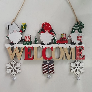 Detail of wooden Christmas Gnome Welcome sign with hanging snowflakes and bells