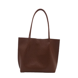 Large dark brown woven tote bag for women with minimalist shoulder straps and vintage texture