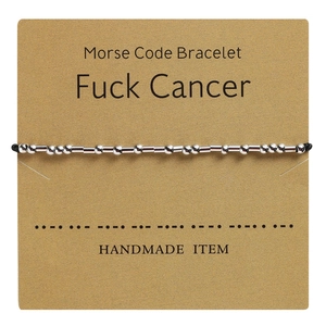 Detail of Fuck Cancer Morse Code bracelet with silver beads on a handmade display card