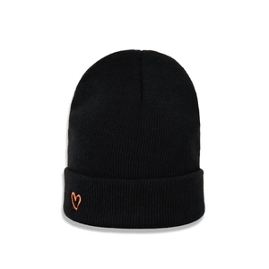 Close-up of black knitted beanie featuring high-quality orange heart embroidery on the cuff