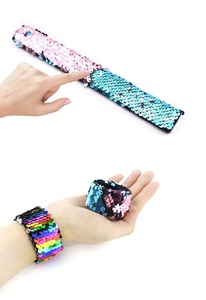 Detail of reversible mermaid sequin slap bracelets showing color changing flip action