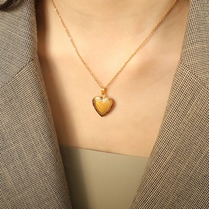 Vintage gold heart locket necklace for women featuring detailed embossed texture