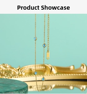 Macro shot of 18K gold plated stainless steel necklace with blue evil eye beads detail