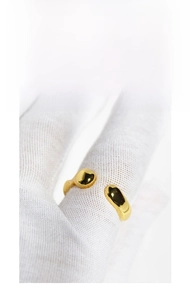 Macro shot of minimalist gold wave adjustable ring with liquid metal drop design