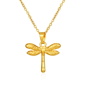 Macro detail of golden dragonfly pendant necklace with polished metal finish and O-chain link