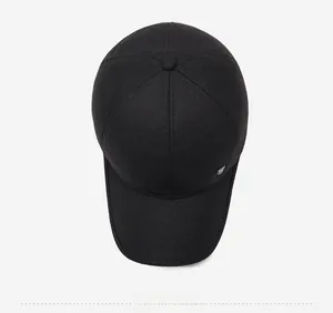 Top view of black winter baseball cap showing textured fabric and metallic side logo detail