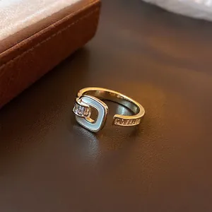 Adjustable gold plated square buckle ring with white enamel and sparkling zircon stones